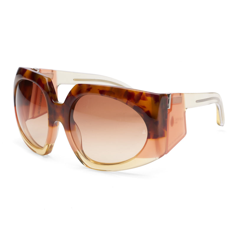 Side profile of Jacques Marie Mage Duval Sunfade sunglasses: thick acetate side shield, sculpted temple that transitions from tortoiseshell front to lighter amber/pink base. Gradient brown lens visible from angle; hinge detail exposed