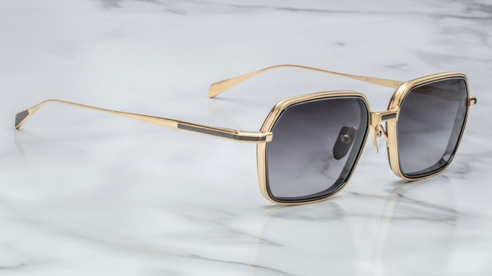 Side view of Jacques Marie Mage Admiral Cia sunglasses showing sleek black beta-titanium arms and subtle gold detailing, handcrafted in Japan.