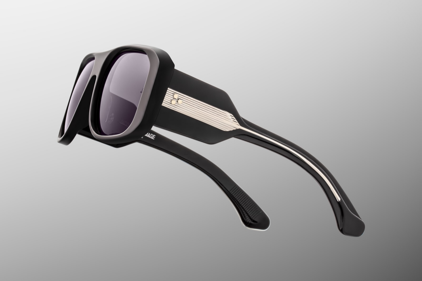 Close up temple detail of Jacques Marie Mage Alfie Shadow sunglasses showing engraved wire core inside black acetate temples – available at Wink Optometrists