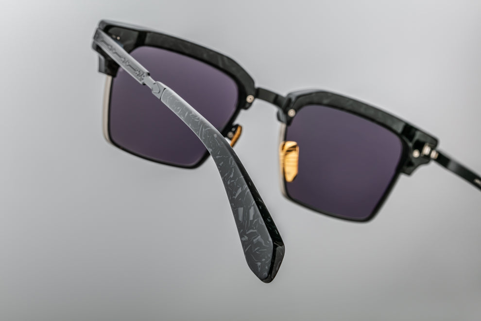 The back view of the JMM (Jacques Marie Mage) Alin Slate frames shows black-engraved titanium temples with acetate tips and a light black tension-secured custom arrowhead monoblock hinge