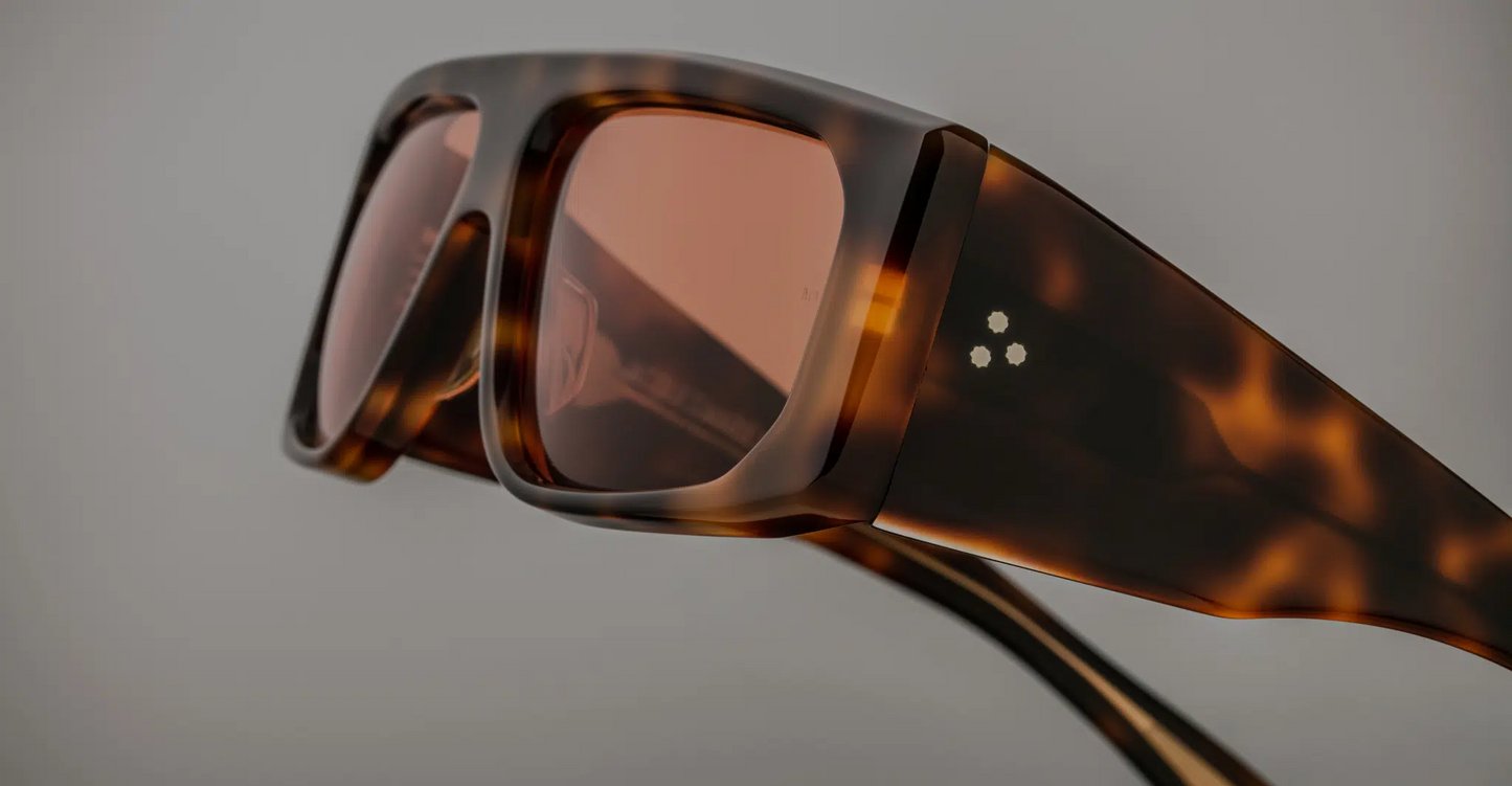 Close-up of the temples of Jacques Marie Mage Cliff Havana 7 sunglasses, showcasing the fine gold-tone metal detailing and the premium Havana acetate. The temple tips are smoothly tapered, and the craftsmanship is precise, contributing to a sophisticated and elegant design