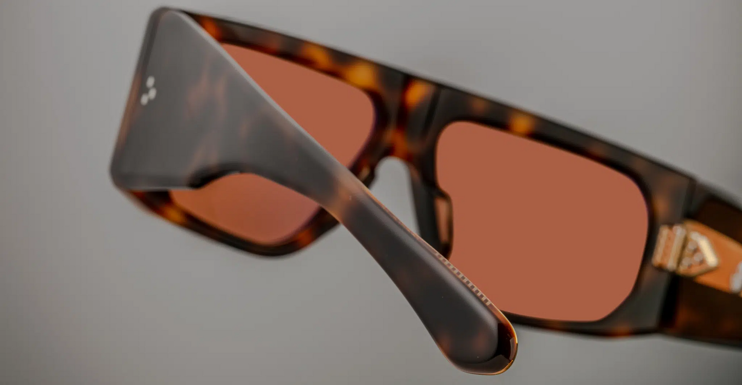 Back view of the Jacques Marie Mage Cliff Havana 7 sunglasses, revealing the smooth, clean lines of the frame’s temples. The rich Havana acetate continues around the temples, with a subtle shine that highlights the material's depth and texture. The gold-tone metal accents at the temple ends add a touch of luxury