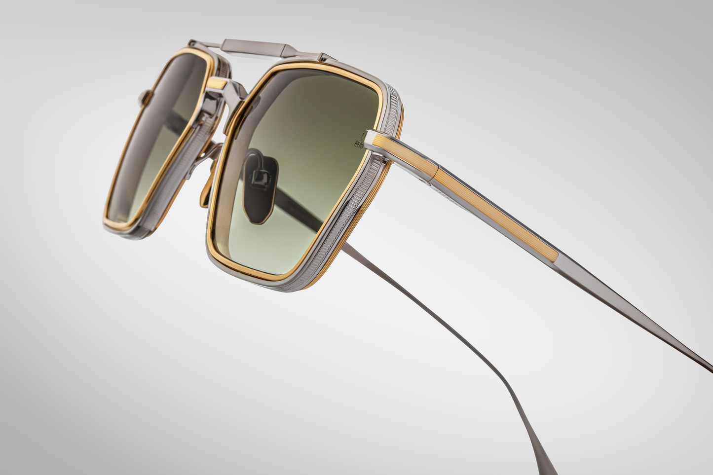 Close-up of Jacques Marie Mage Commodore Silver sunglasses revealing engraved titanium temples and custom hinge hardware.