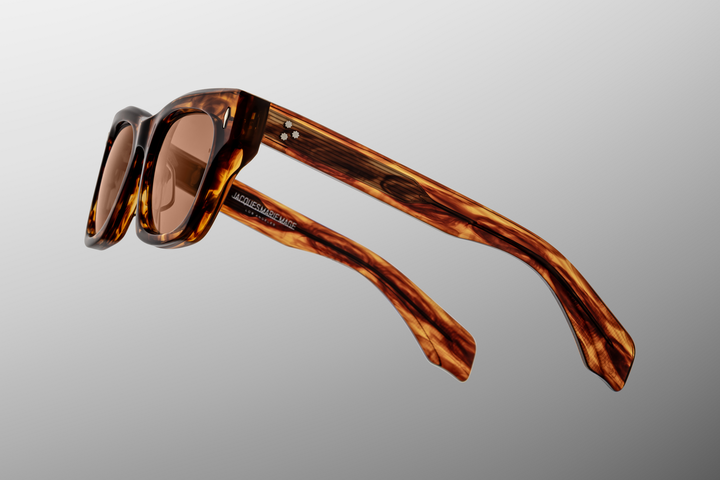Close up temple detail of Jacques Marie Mage Dealan Bourbon sunglasses showing engraved wire core inside tortoiseshell acetate temples – available at Wink Optometrists