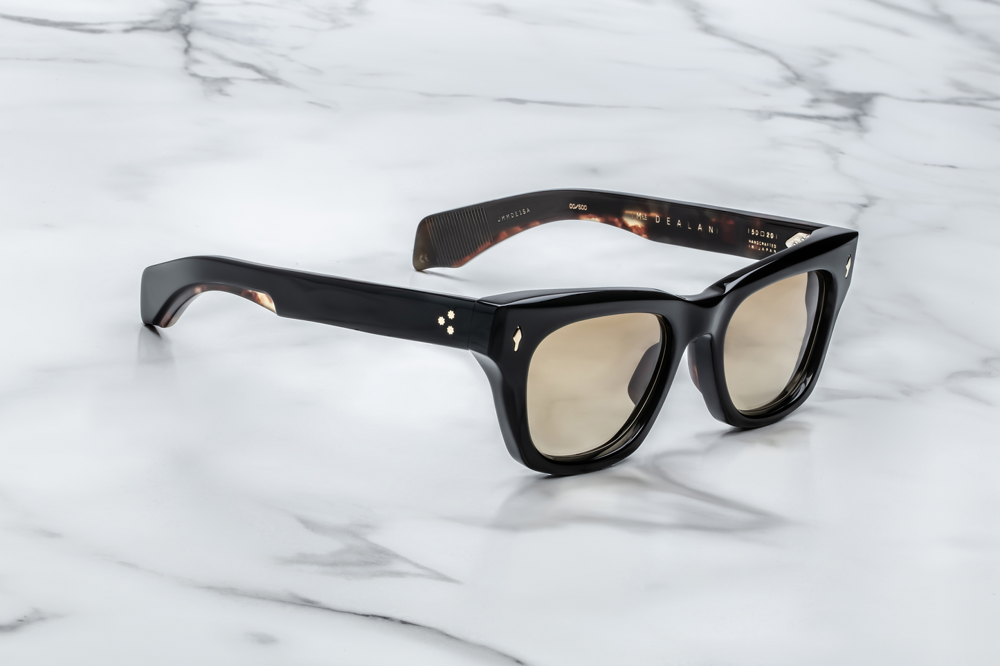 Side view of Jacques Marie Mage Dealan 53 Noir 15 sunglasses, highlighting the smooth, angular lines of the temples. The black acetate frame is paired with delicate gold-tone metal accents at the temple ends, adding a touch of elegance and luxury to the bold design. The temples have a refined, tapered shape for a sleek finish