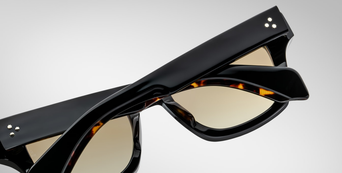 Back view of Jacques Marie Mage Dealan 53 Noir 15 sunglasses, showing the smooth black acetate finish that wraps around the temples. The gold-tone metal detailing at the temple tips provides a luxurious contrast to the deep, solid hue of the frame, enhancing the overall sophisticated design