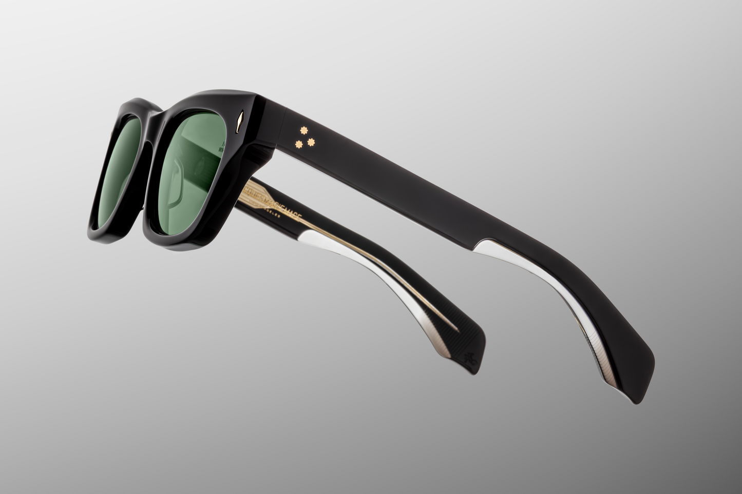 Close up temple detail of Jacques Marie Mage Dealan Venom sunglasses showing engraved wire core inside green acetate temples – available at Wink Optometrists