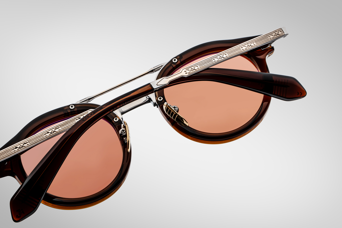 Side profile of Jacques Marie Mage Delage Zoltar highlighting brown acetate temple, fine Art‑Deco engraving, custom arrowhead monoblock hinge in light gold, and exposed sterling‑silver beta‑titanium structure.”