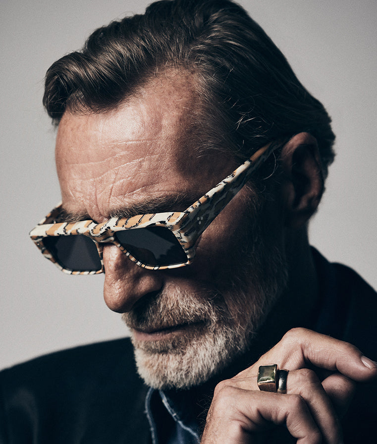 Portrait of a model wearing Jacques Marie Mage Devoto (Cheetah) sunglasses at WINK Optometrists, Melbourne — bold cheetah‑print acetate rectangular frame with grey lenses and strong brow‑line