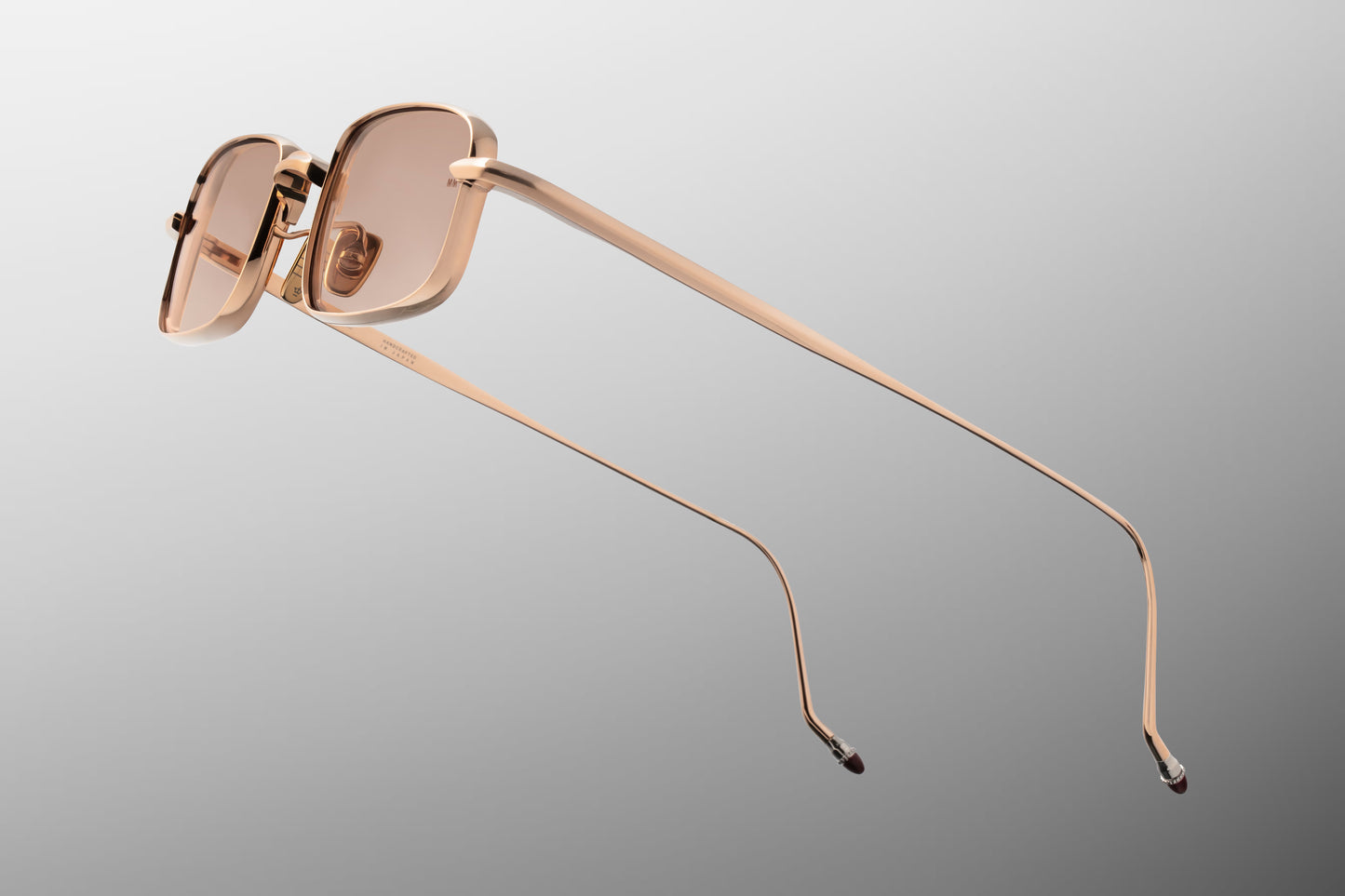 Side view of the Jacques Marie Mage Dusk Sweetheart sunglasses, highlighting the ultra-fine sculptural beta titanium temple arms in polished rose gold and the contrasting hand-painted burgundy epoxy temple tips