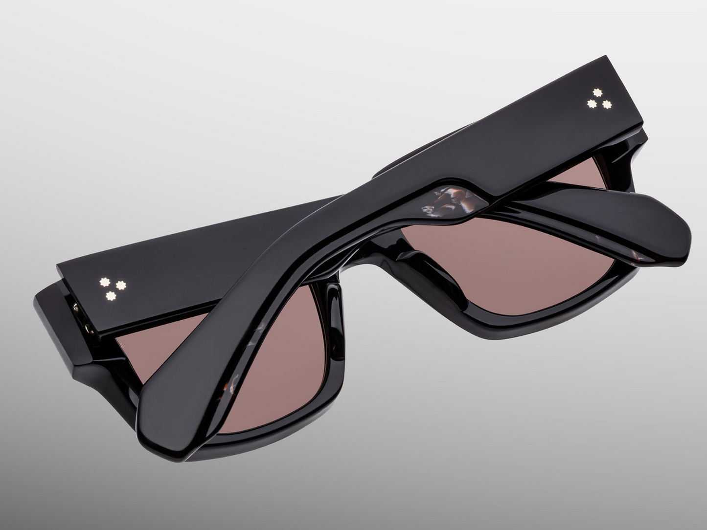 Back view of Jacques Marie Mage Enzo (Willow) sunglasses — interior of temples showing model serial number, black acetate finish, brown lens backside with anti‑reflective treatment.