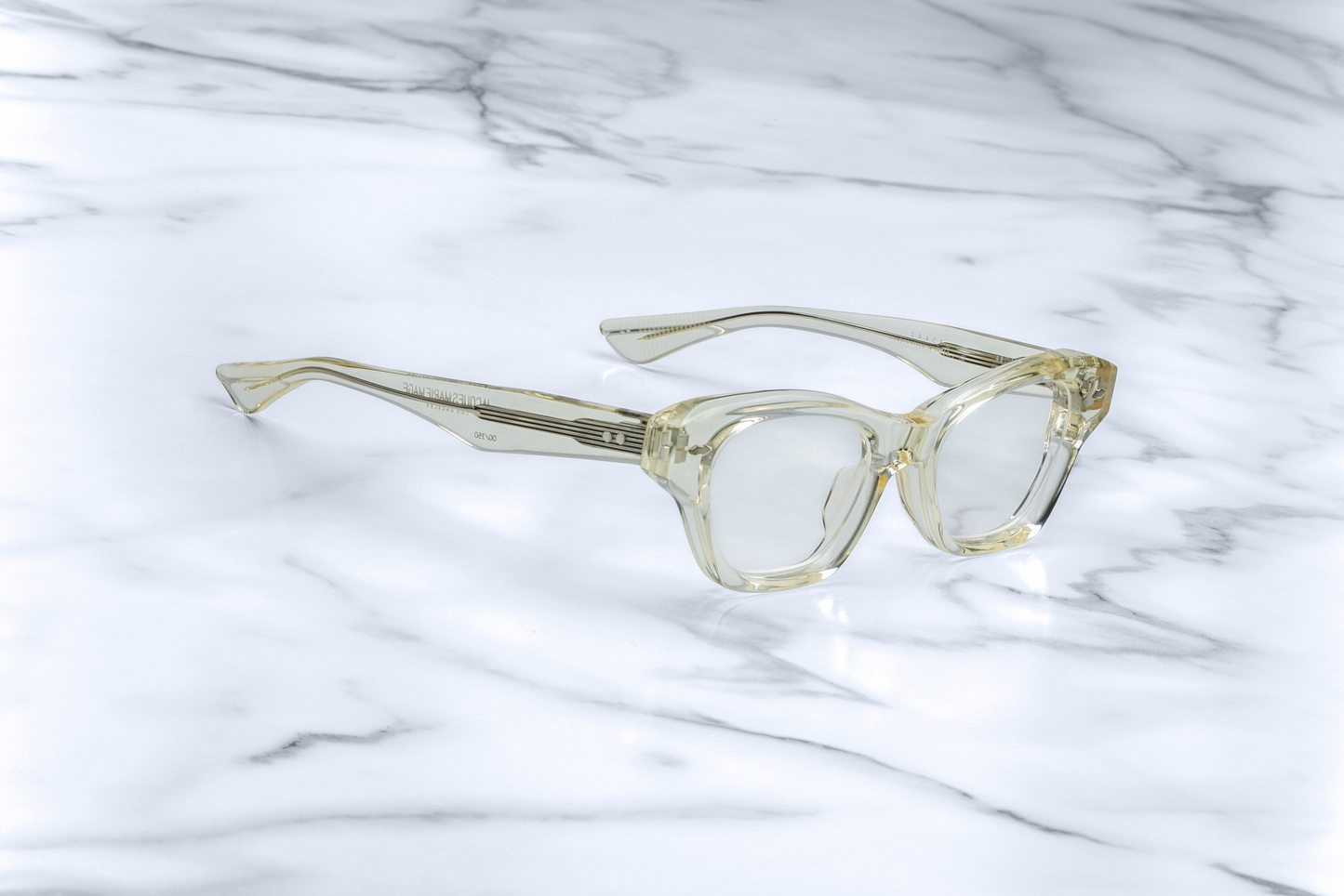 ide profile of Jacques Marie Mage Grace 2 sunglasses in Sunkiss, highlighting the slim acetate temples and tension-secured custom hinge. The frame's gentle silhouette and subtle lift in the eye area are emphasized, offering a balanced and elegant appearance.