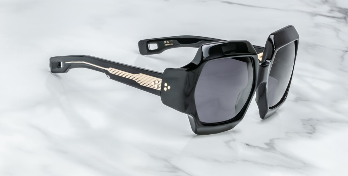 Side view of Jacques Marie Mage Grandfunk Black sunglasses, showcasing the thick black acetate temples with clean, angular lines. The temples feature subtle gold-tone metal accents at the tips, adding a touch of refinement. The strong frame shape creates a modern, sophisticated look from the profile.
