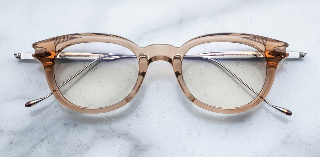 Front view of Jacques Marie Mage Hisao optical glasses in Sand, featuring a rectangular silhouette crafted from translucent beige acetate with clear lenses