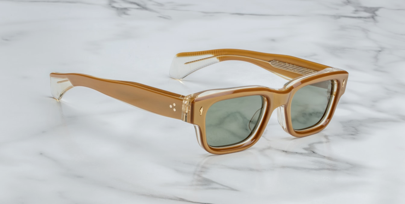Side view of Jacques Marie Mage Jeff sunglasses in Gold, highlighting the sleek gold-tone metal temples with unique, engraved detailing. The frame's rounded shape is balanced by the subtle curvature of the temples, which taper gracefully for a comfortable, stylish fit. The frame exudes high-end craftsmanship and modern elegance