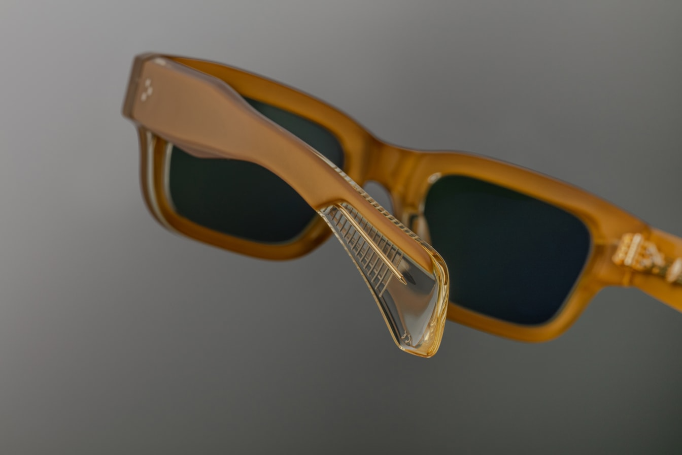 Back view of Jacques Marie Mage Jeff sunglasses in Gold, showing the smooth, polished gold-tone metal temples. The finely crafted hinge and temple tips are visible, with a luxurious finish that complements the vintage-inspired round frame. The attention to detail and precision in the design is evident from this angle