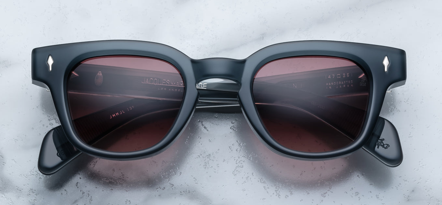 Front view of JMM Julien Mink sunglasses: moderate Wellington‑shape in 10 mm mink‑grey cured cellulose acetate, keyhole bridge, 47mm‑wide lenses with heather gradient CR‑39 pink tint, arrowhead silver front pin