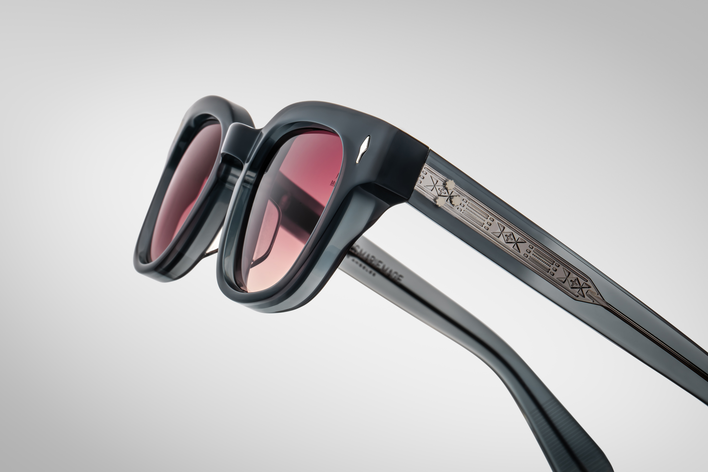 Side view of Julien Mink: double‑laminated acetate temples in matching mink grey, exposed silver wire‑core, tension‑secured 7‑barrel custom hinge, slim silhouette with 143 mm temple length