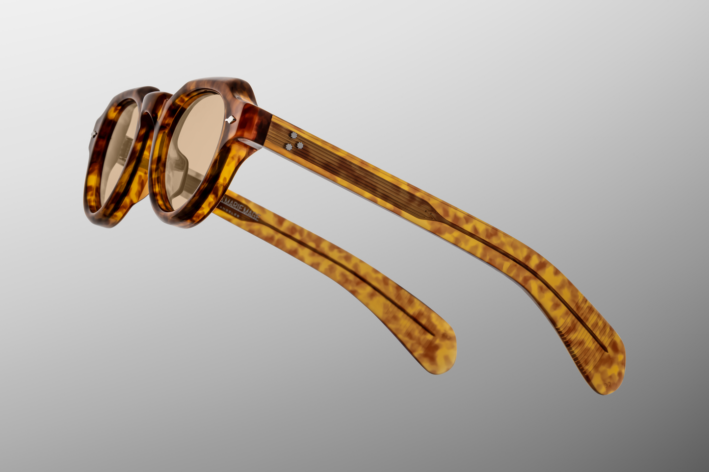 Close up detail of Kellerman Camel: section where lens meets frame, showing bevels and polish of the acetate, the arrowhead pin detail, and the texture/pattern of the camel tone under light