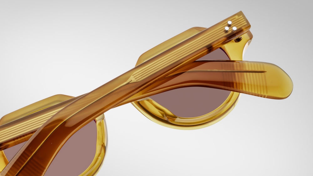 Back view of Jacques Marie Mage Kellerman Honey sunglasses, showcasing the yellow-toned acetate frame with sculpted brow and cheek contours. The light gold arrowhead front pins and hidden wirecore details are prominently displayed, reflecting the frame's artisanal craftsmanship