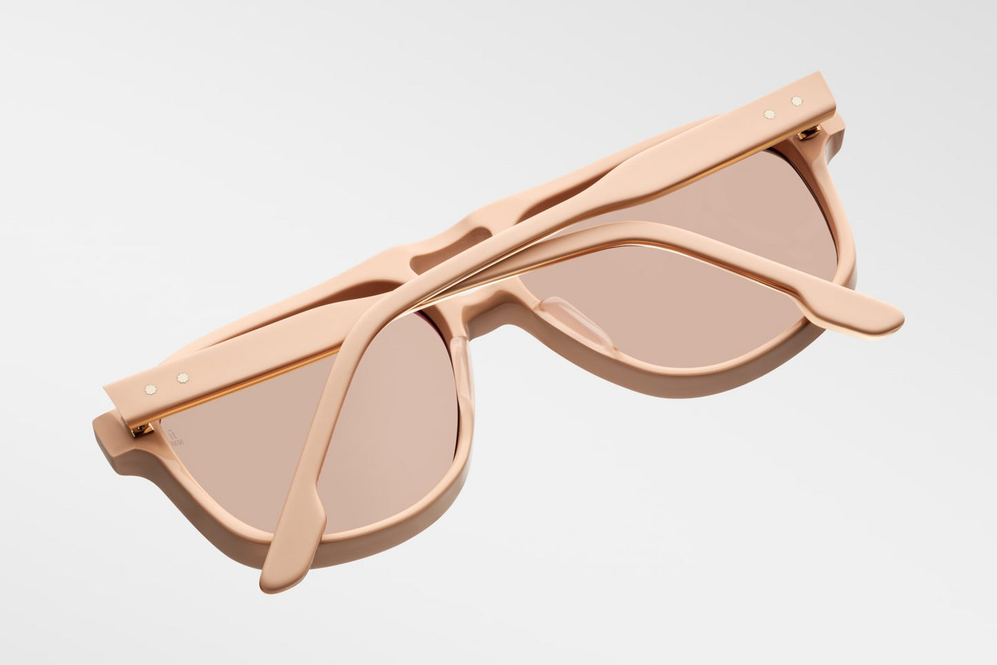 Bottom-up view of Jacques Marie Mage Leonard Suede sunglasses in Dust Suede: emphasizes the thickness of the acetate frame and the distinctive shape of the lenses. The light gold wirecore is visible along the inner edge of the temples.