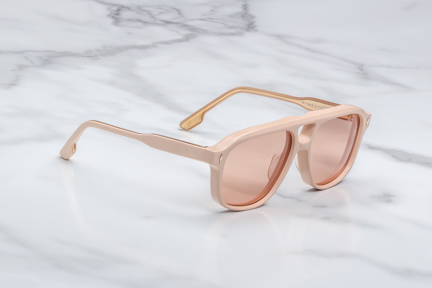 Side profile of Jacques Marie Mage Leonard Suede sunglasses in Dust Suede: showcases the thick acetate front transitioning into slim, sculpted temple arms. The temples are custom double-laminated acetate with light gold metal accents and Vauxhall wirecore exposed along the inner edge.