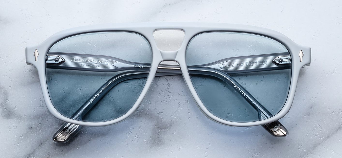 Front view of Jacques Marie Mage Leonard Suede sunglasses in Sky Suede: oversized navigator-style frame in matte blue cellulose acetate, featuring a balanced double-bridge design. The frame includes sterling silver arrowhead front pins and Vauxhall wirecores with refined hairline details