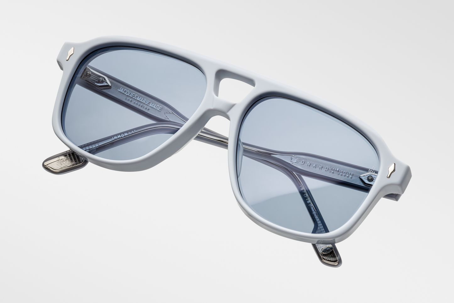 Top-down view of Jacques Marie Mage Leonard Suede sunglasses in Sky Suede: reveals the smooth, tactile matte exterior of the acetate frame and the curvature of the lenses. The double-bridge design is visible, showcasing the frame's structure.