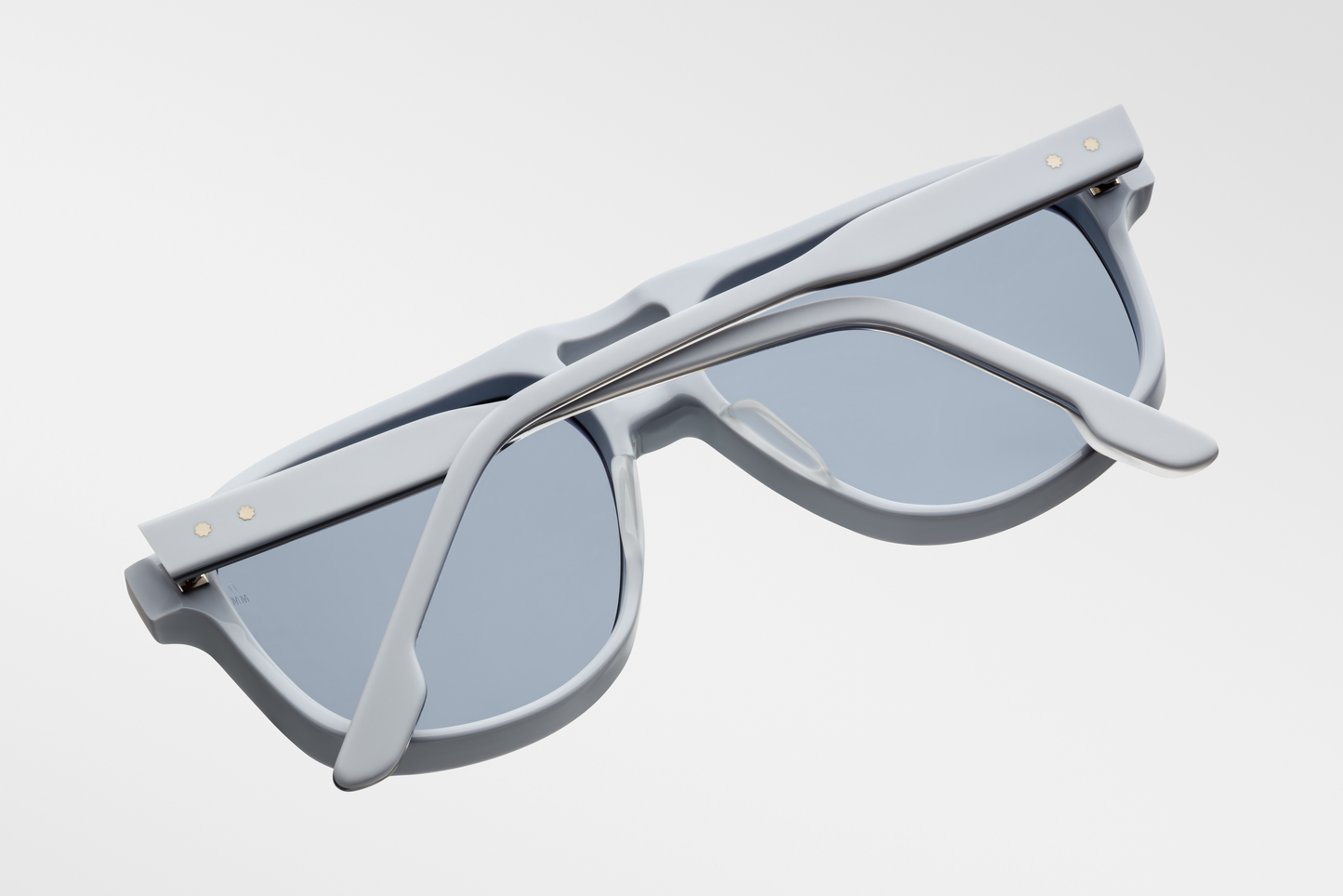 Bottom-up view of Jacques Marie Mage Leonard Suede sunglasses in Sky Suede: emphasizes the thickness of the acetate frame and the distinctive shape of the lenses. The sterling silver wirecore is visible along the inner edge of the temples.