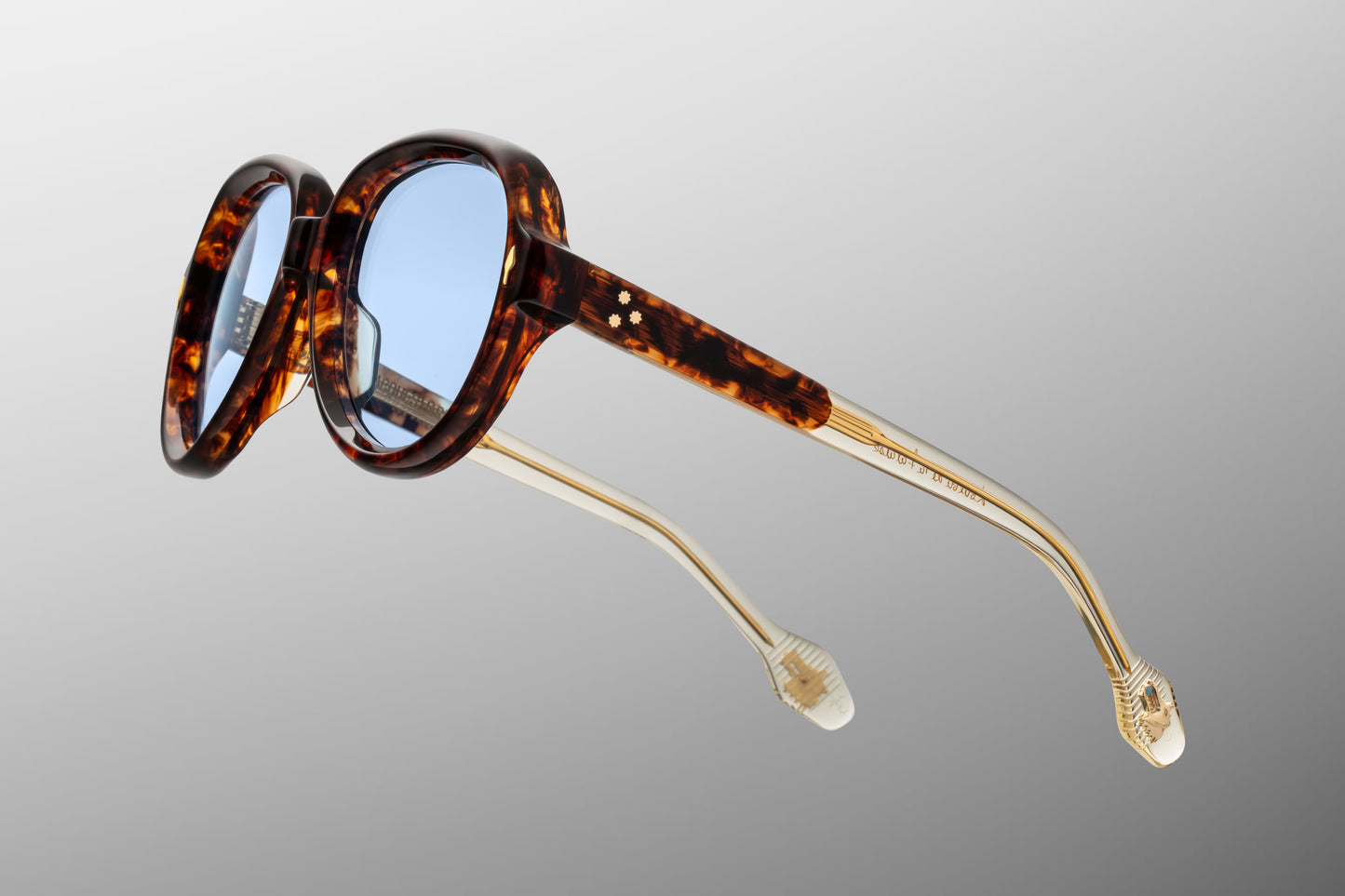 Close-up side detail of Jacques Marie Mage Louise Paris showing engraved wirecore, 7-barrel hinge construction and temple tip medallion
Macro side view of JMM Louise Paris sunglasses highlighting premium hardware and sculptural acetate layering
