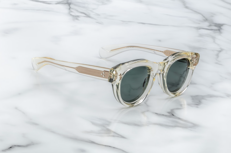 A profile view of the Molitor Brut Spruce sunglasses, highlighting the sculpted acetate temples that taper towards the ear. The temples are custom double-laminated with a light gold wirecore, adding a touch of elegance. The frame's bold lines and oversized design give it a distinct '80s-inspired look.