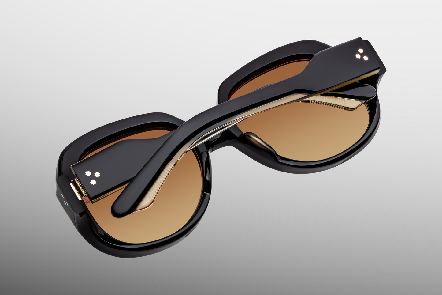 Rear view of Ocean Child Beluga — inside of temples showing clear beige interior acetate with partially exposed dark‑gold wire-core