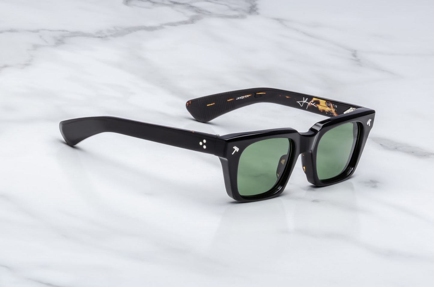 Side profile of Jacques Marie Mage Johnny Cash II Quentin sunglasses in Noir 9: showcases the thick acetate front transitioning into slim, sculpted paddle temples. The temples are custom double-laminated acetate with polished silver metal accents and exposed wirecore along the inner edge.