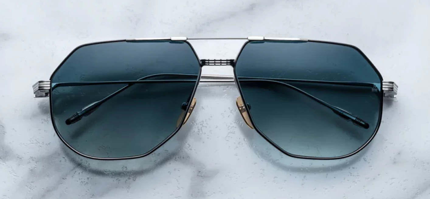 the Jacques Marie Mage Reynold Pacific an oversized, ’70s-inspired titanium aviator in silver and black 100% beta titanium frame , engraved double bridge, signature tail‑fin temples with blue gradient lenses. Limited to j500 handcrafted pieces. WINK Optometrists