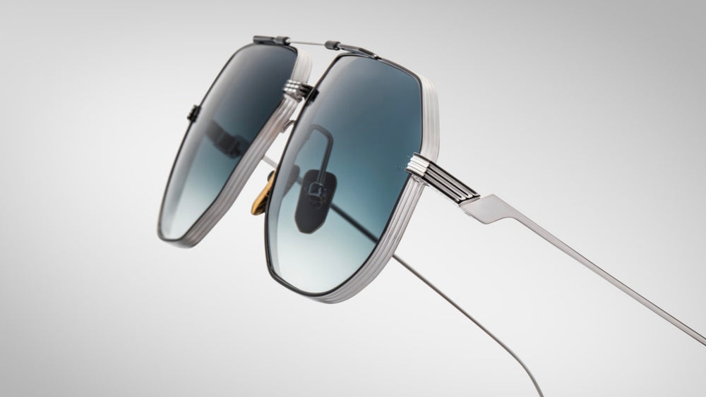 temple detail of the Jacques Marie Mage Reynold Pacific an oversized, ’70s-inspired titanium aviator in silver and black 100% beta titanium frame , engraved double bridge, signature tail‑fin temples with blue gradient lenses. Limited to j500 handcrafted pieces. WINK Optometrists