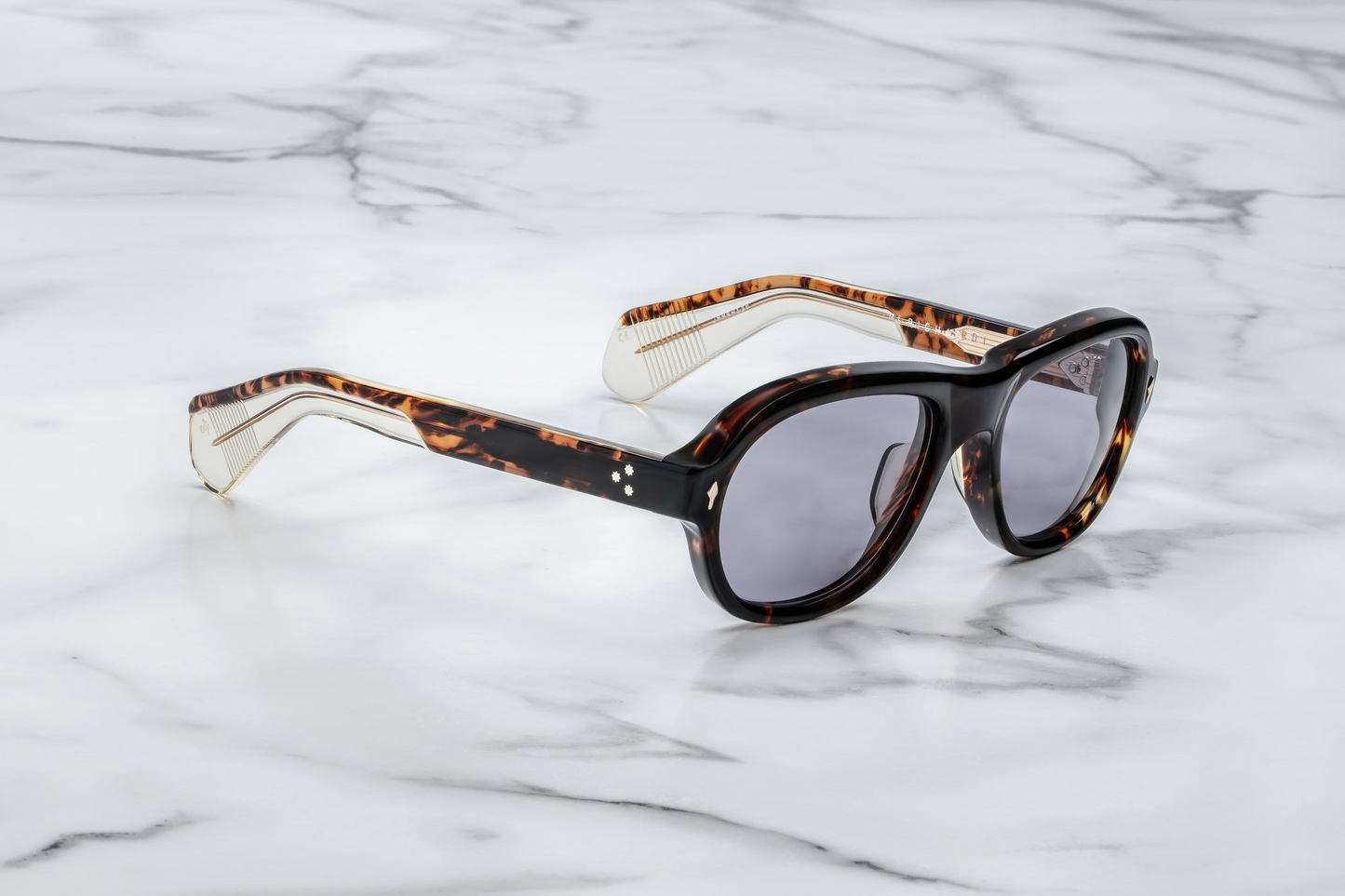 Side profile of Jacques Marie Mage Richard sunglasses in Beau: showcases the thick acetate front transitioning into slim, sculpted temple arms. The temples are custom double-laminated acetate with sterling silver metal accents and a hidden wirecore exposed along the inner edge.
