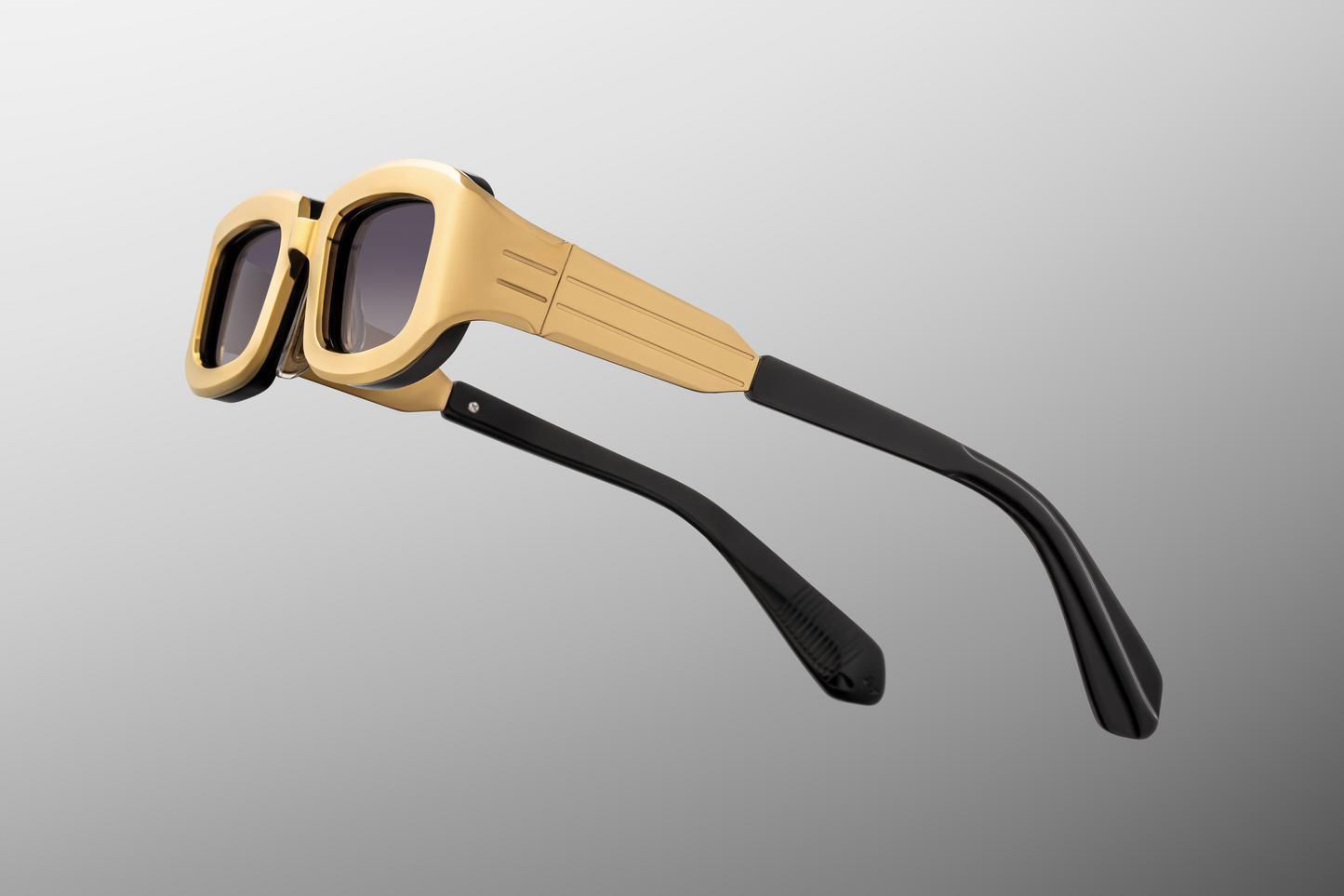 Close up temple detail of Jacques Marie Mage Ryder Gold sunglasses showing engraved metal temples and luxury titanium eyewear design – available at Wink Optometrists