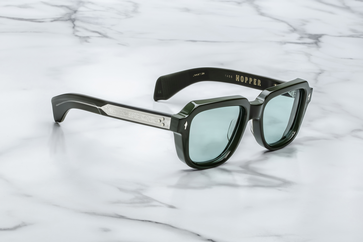 Side view of TAOS Mink by Jacques Marie Mage: thick double‑laminated mink acetate temples, exposed wire‑core detailing, triple spur rivets at hinge, gold hardware connectors