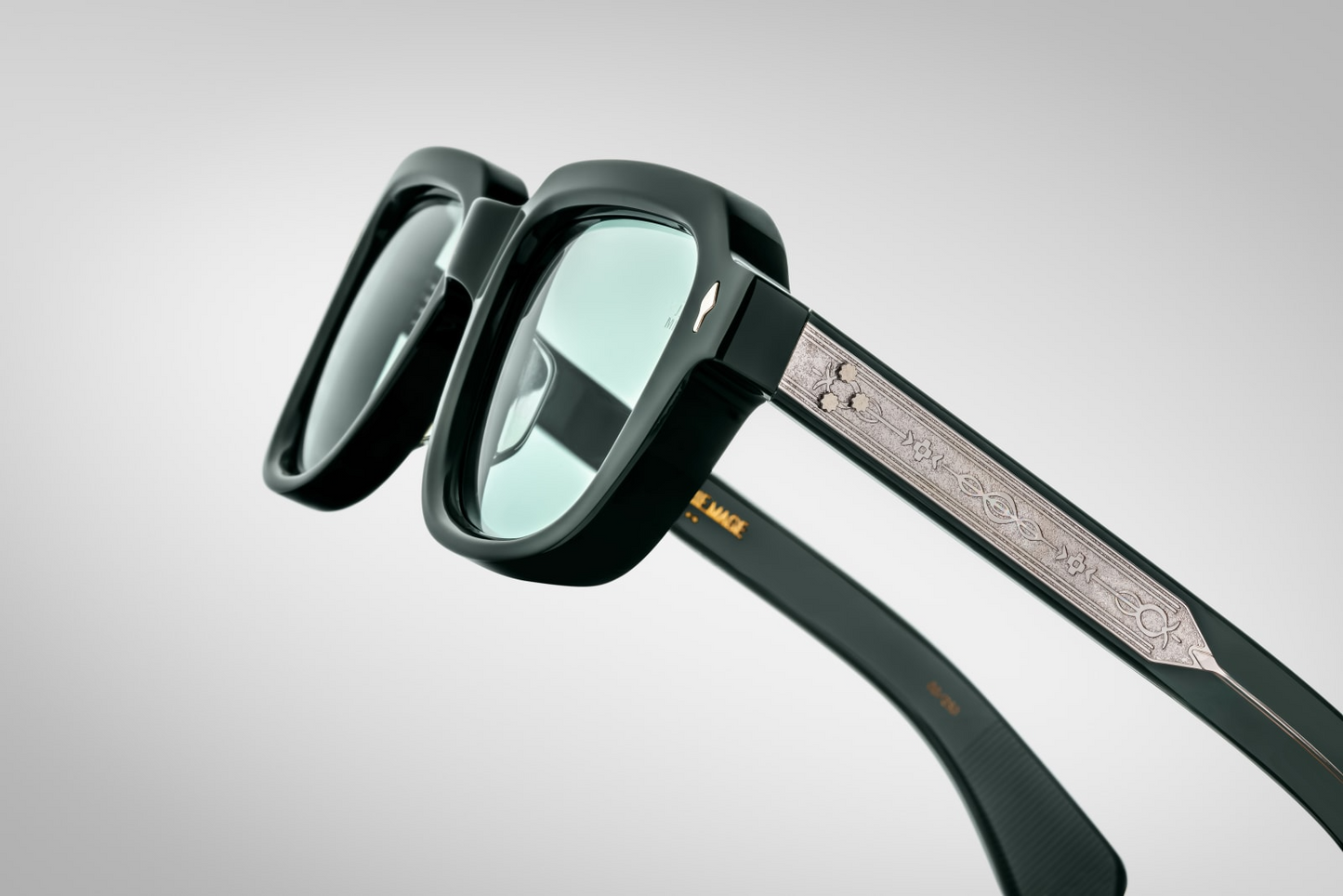Side view of TAOS Mink by Jacques Marie Mage: thick double‑laminated mink acetate temples, exposed wire‑core detailing, triple spur rivets at hinge, gold hardware connectors