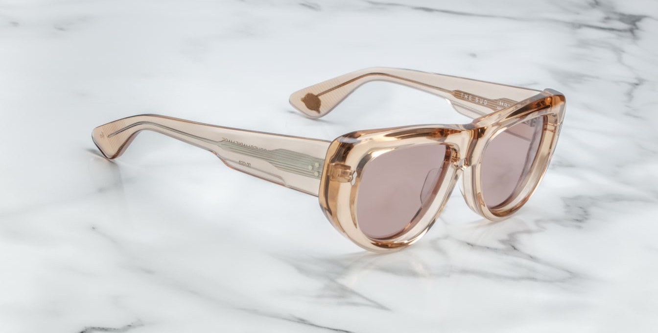 Jacques Marie Mage The Sud | Simone sunglasses from the Erin Wasson x JMM collection in translucent “Clear Sand” acetate. Bronze tinted CR39 lenses with a 6 base curve, backside anti-reflective coating, and 100 % UV protection. Temple tips are inlaid with a polished silver Crest of Marseille emblem. Handcrafted in Japan as part of a limited run of 350