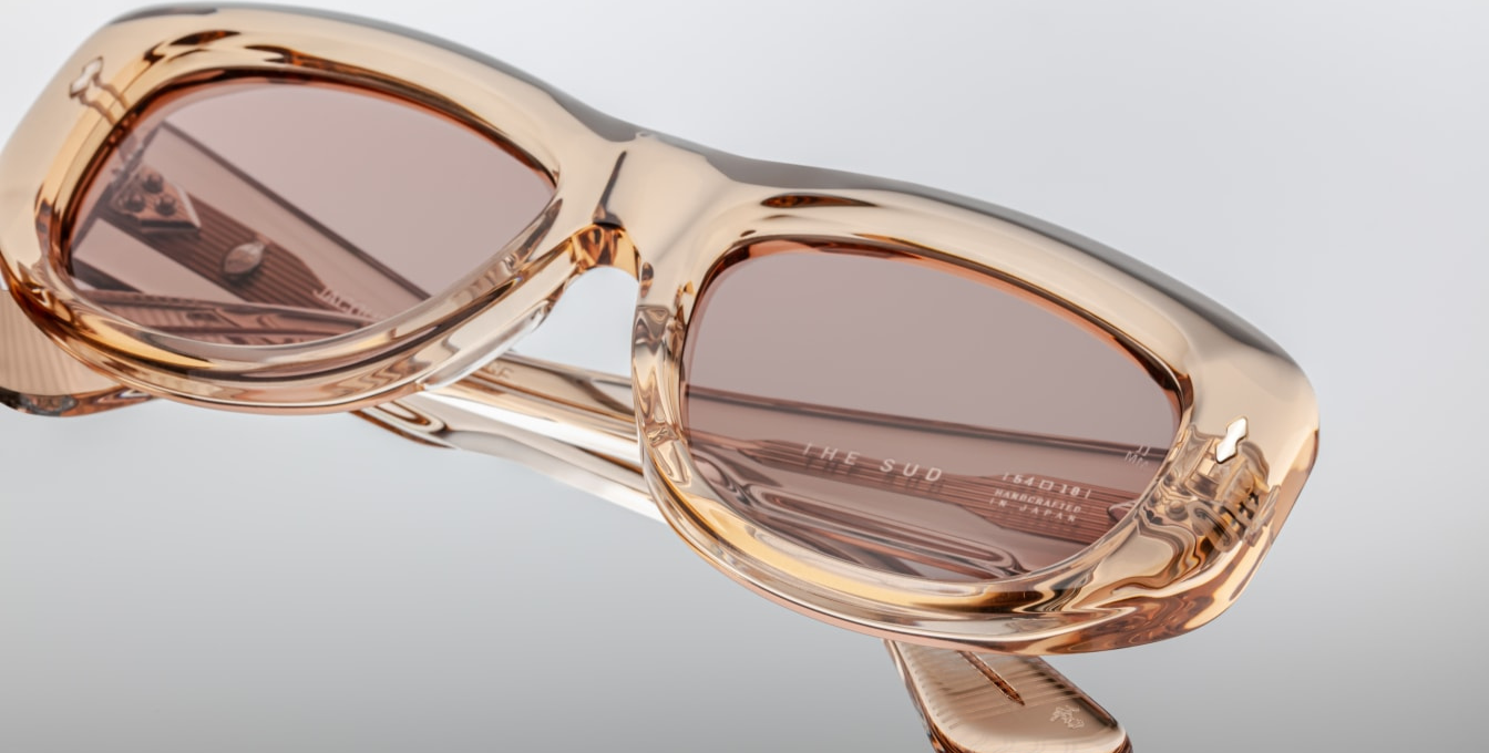 Jacques Marie Mage The Sud | Simone sunglasses from the Erin Wasson x JMM collection in translucent “Clear Sand” acetate. Bronze tinted CR39 lenses with a 6 base curve, backside anti-reflective coating, and 100 % UV protection. Temple tips are inlaid with a polished silver Crest of Marseille emblem. Handcrafted in Japan as part of a limited run of 350