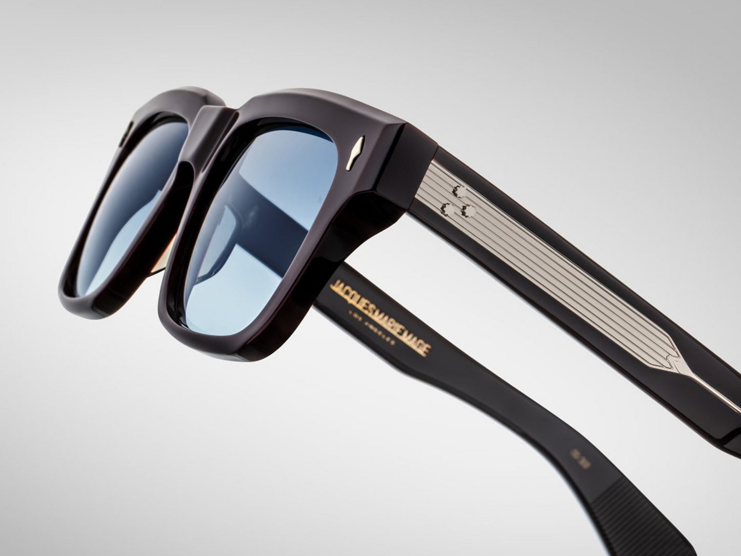 Side view of Molino Wine — double-laminated wine acetate temples revealing the exposed sterling silver engraved wire-core and custom 7-barrel hinge