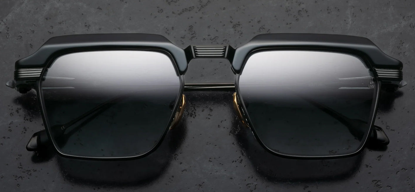 Black sunglasses with reflective lenses on a dark textured background