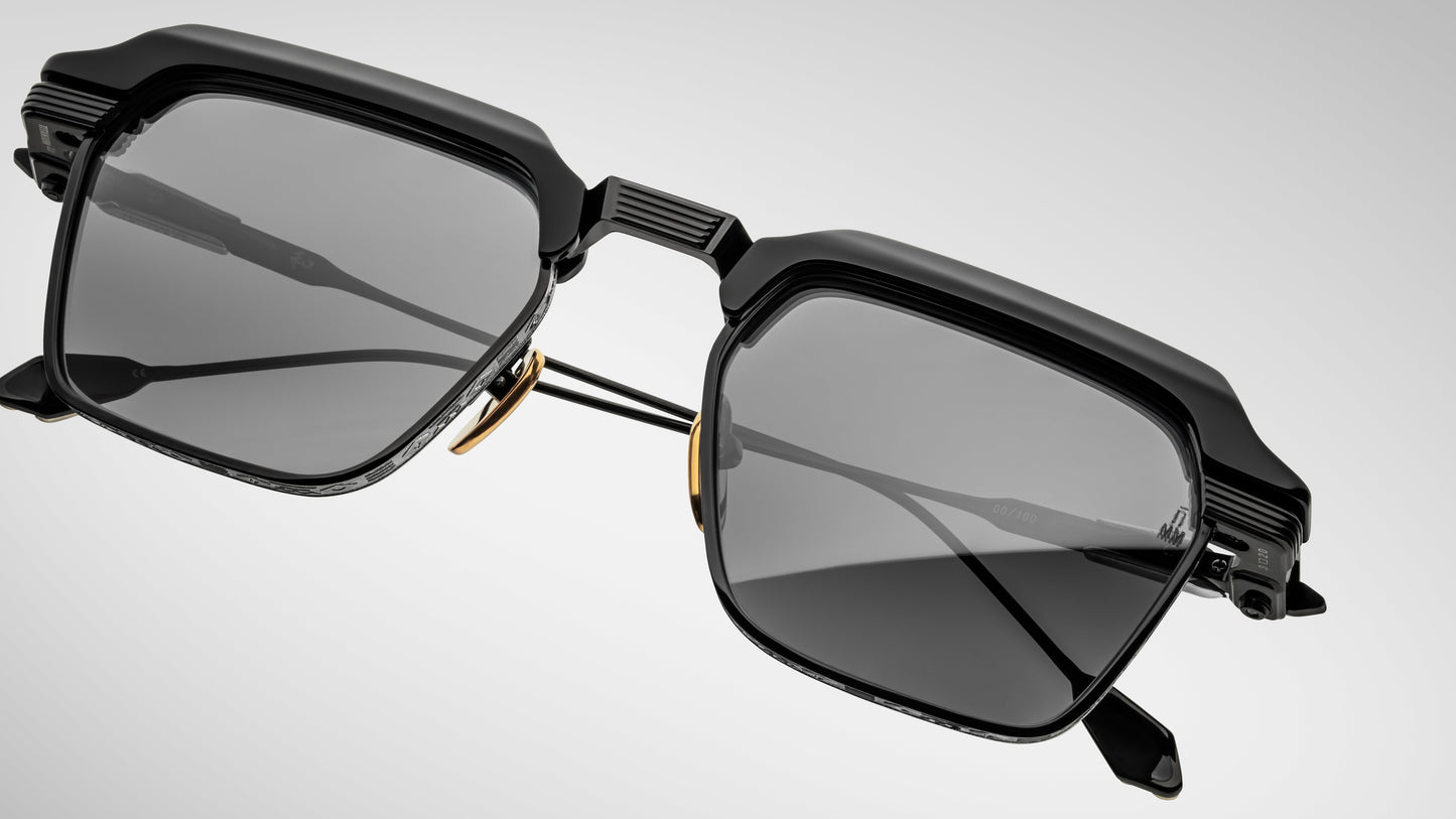 Black sunglasses with a futuristic design on a light gray background