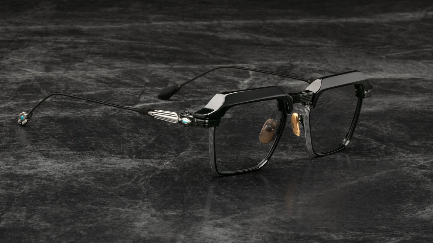 Black eyeglasses on a textured dark surface