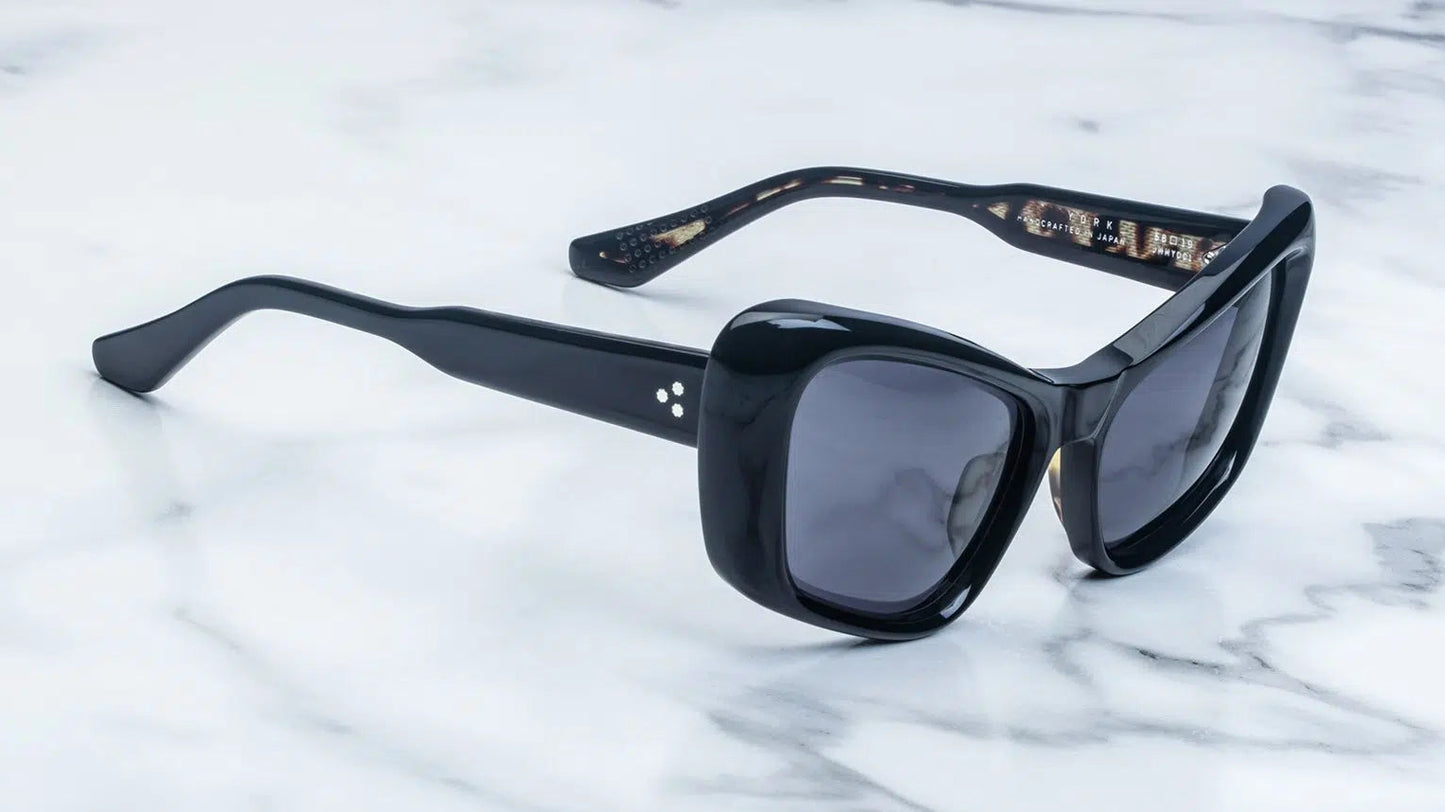 Black sunglasses on a marble surface