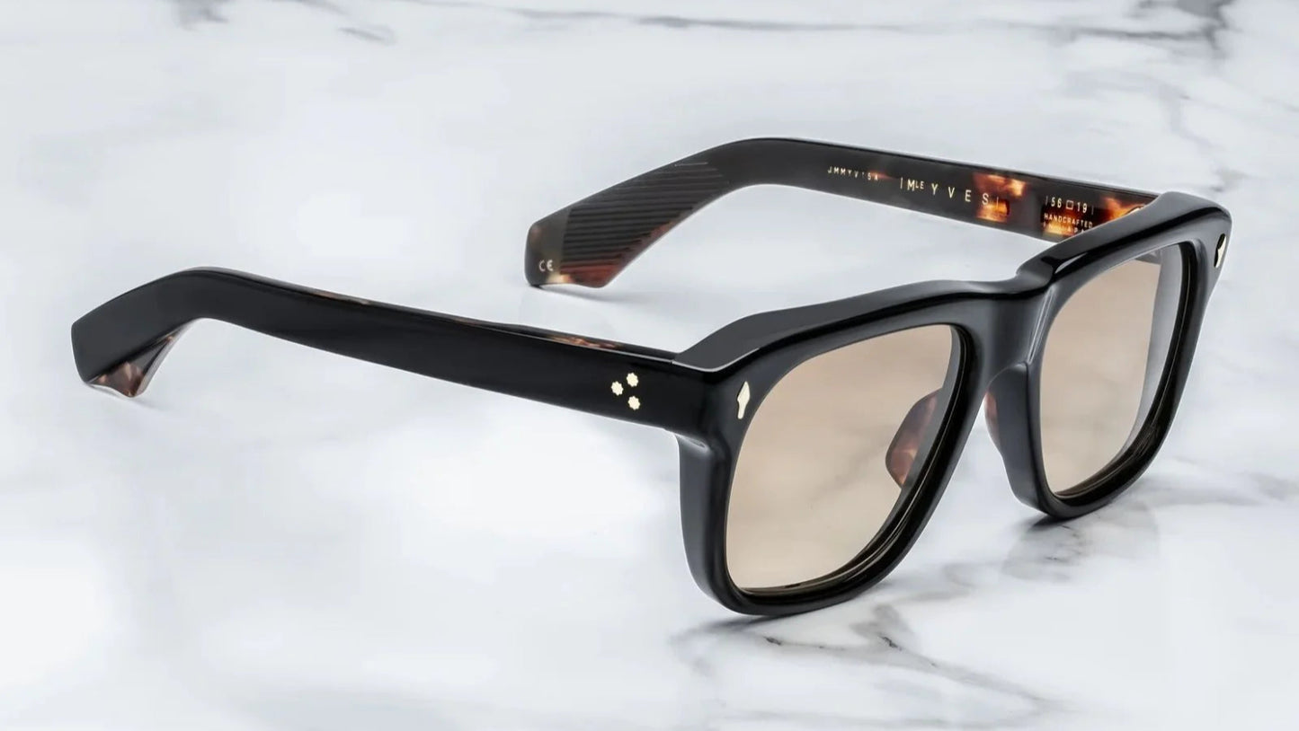 Black eyeglasses on a marble surface