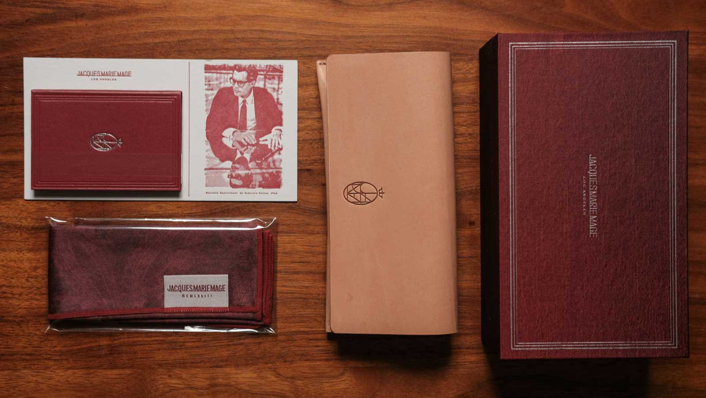 Collection of leather products including wallets and a box on a wooden surface