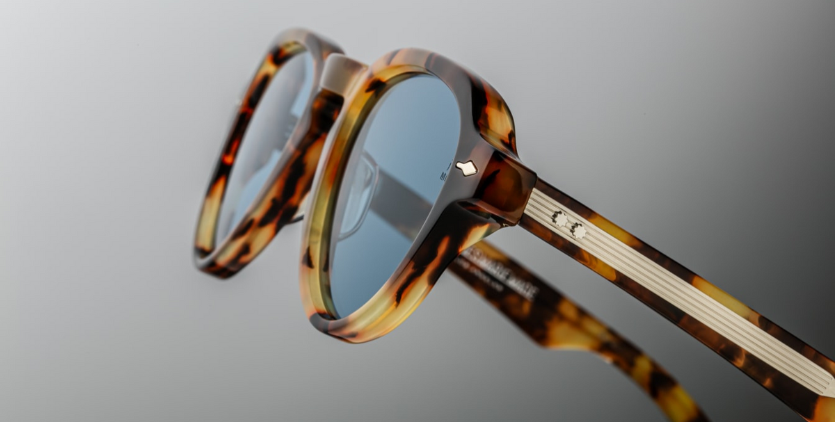 Close-up of the custom double-laminated temples of Jacques Marie Mage Hatfield sunglasses in Havana 8, showcasing sterling silver arrowhead front pins and exposed silver wirecore with custom hairline engraving. The temples feature silver tension-secured custom 5-barrel hinges, combining retro aviator aesthetics with modern craftsmanship