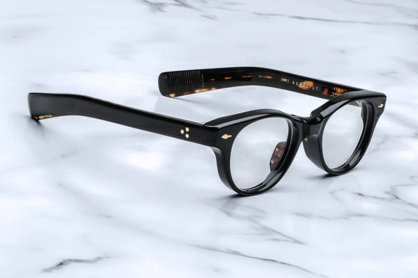 The Aurelius optical frame is sleek, sculptural, and balanced with classic round lenses, paddle temples, and an aviator essence. Limited-edition glasses reminiscent of the boldly designed eyewear expressions emanating from Italy in the early '70's. 10mm brown cellulose acetate frame. Handcrafted in Japan. Size 47/21.